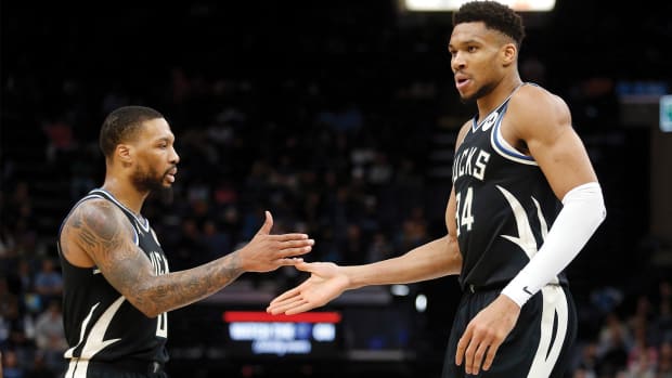 Milwaukee Bucks guard Damian Lillard and Milwaukee Bucks forward Giannis Antetokounmpo high five.